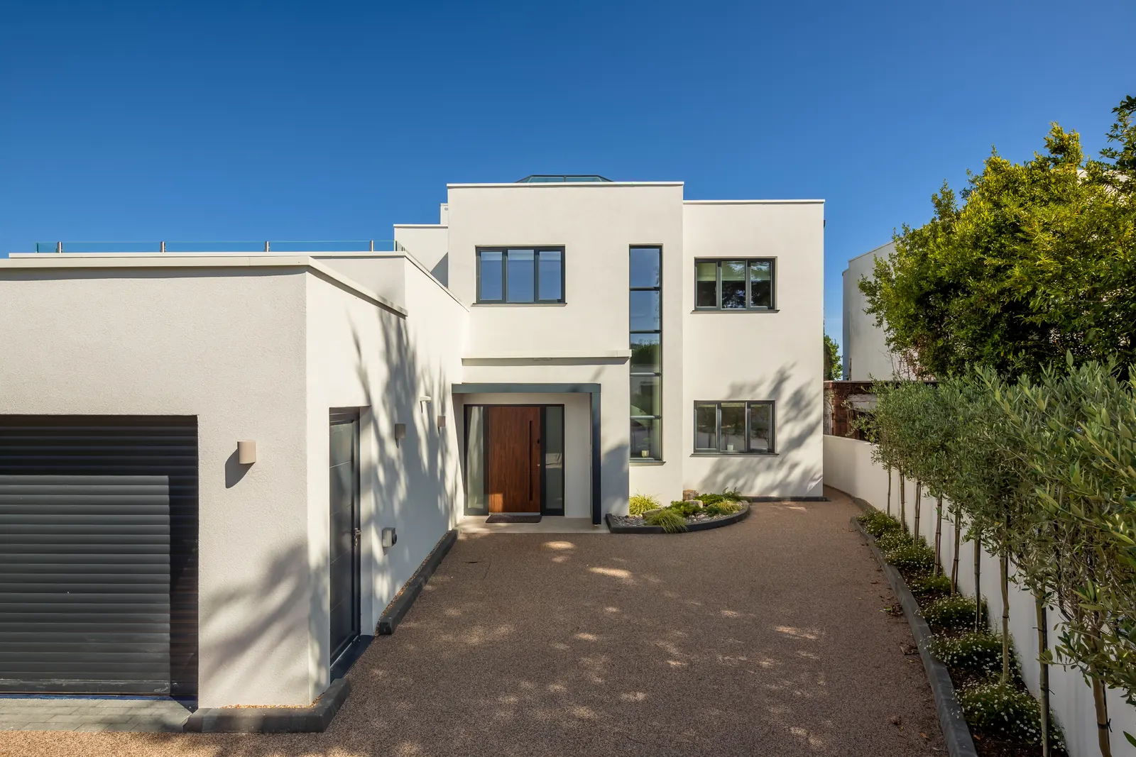 The approach to Skippers Retreat — private drive, garage and the front door