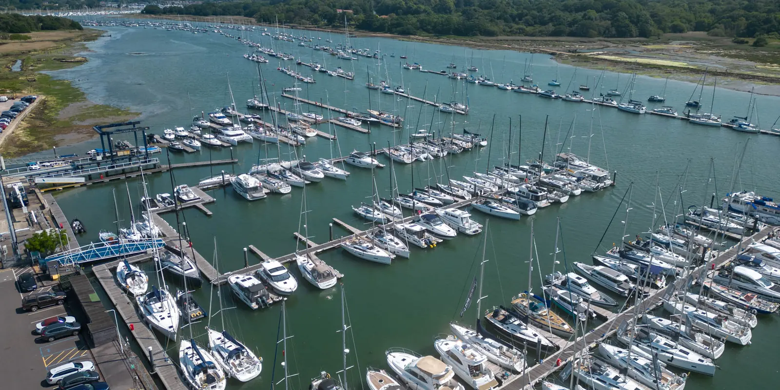 Port Hamble Marina from the air — pontoons of yachts along the River Hamble, with the Solent beyond