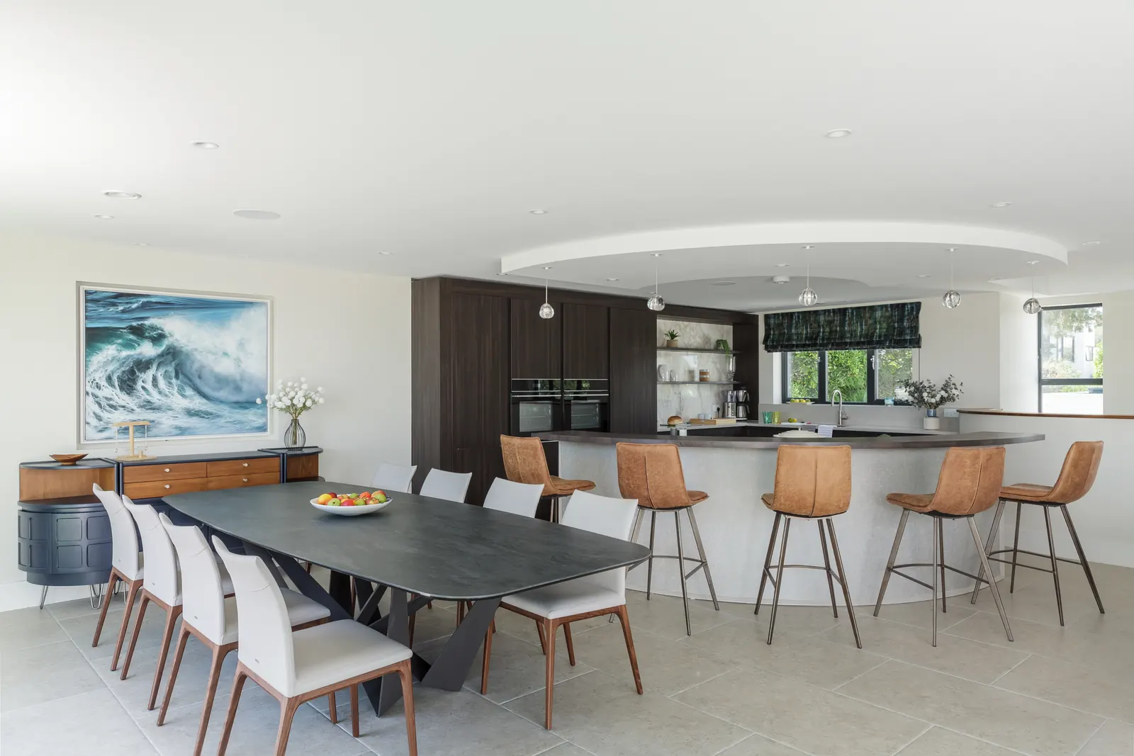 The dining table laid for ten, with the breakfast bar and kitchen behind